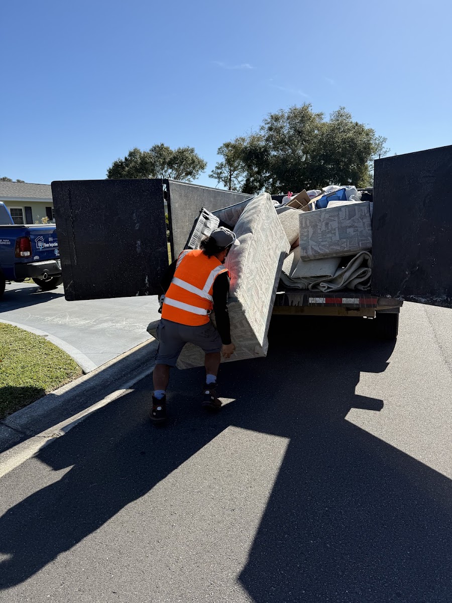 Junk removal in progress at a garage